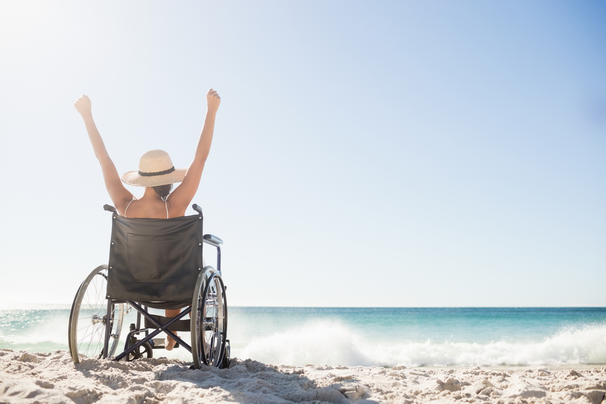 Wheelchair woman sitting with arms up